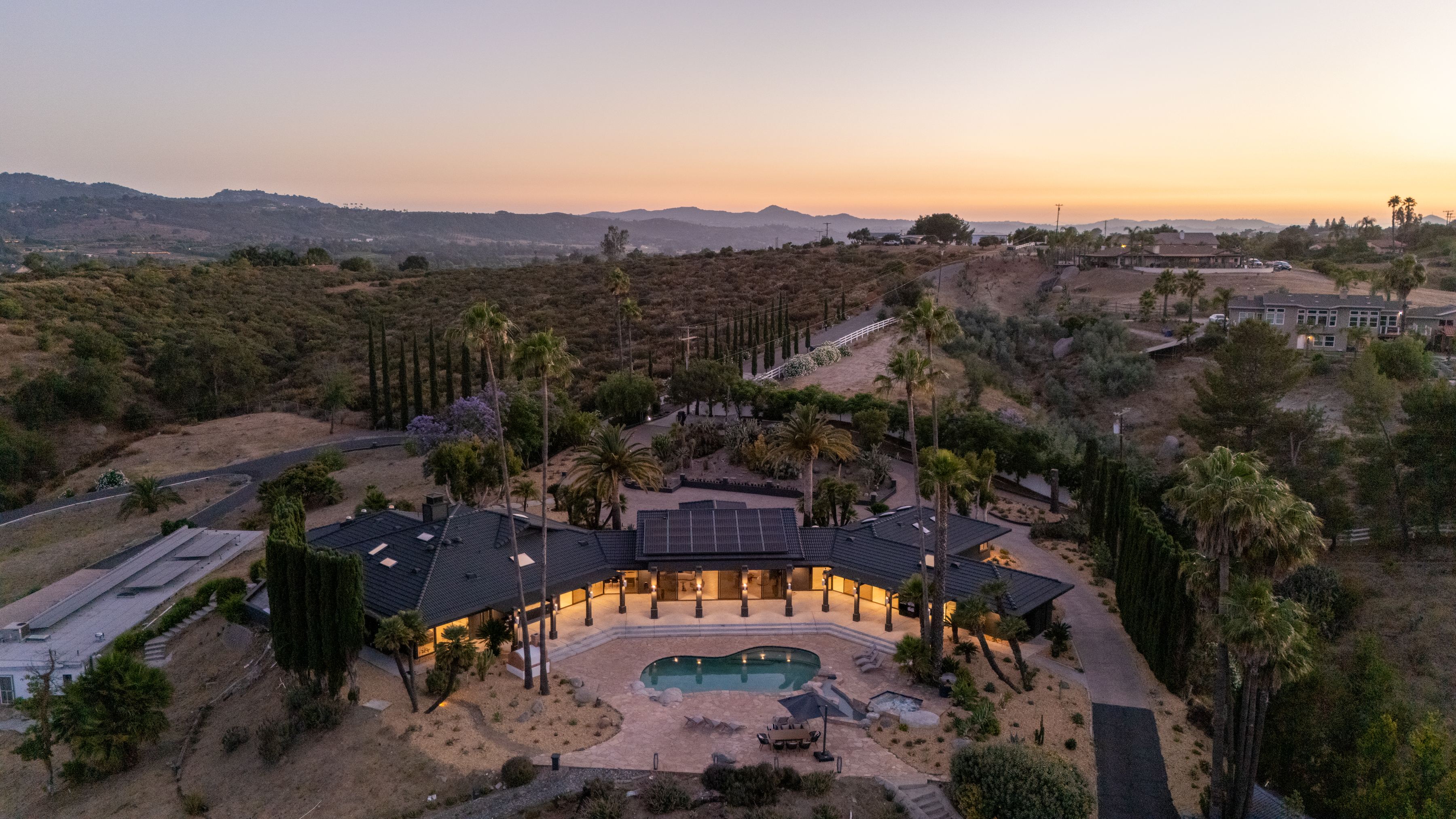 Casa Del Sol aerial sunset view - full property with pool and valley