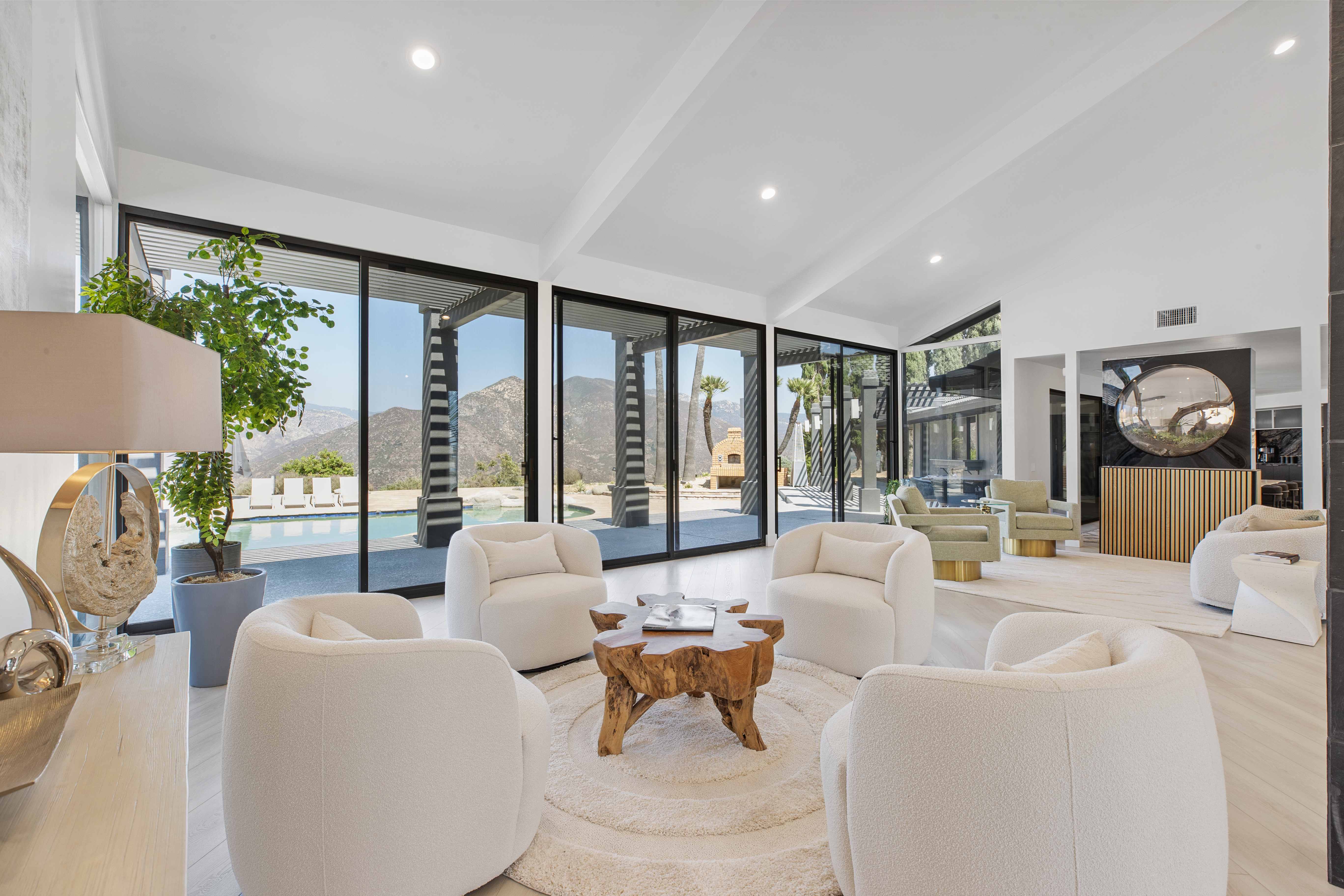 Lounge area with white chairs and floor-to-ceiling glass doors
